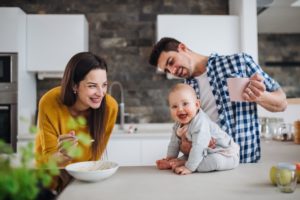 Happy family with baby sitting on counter